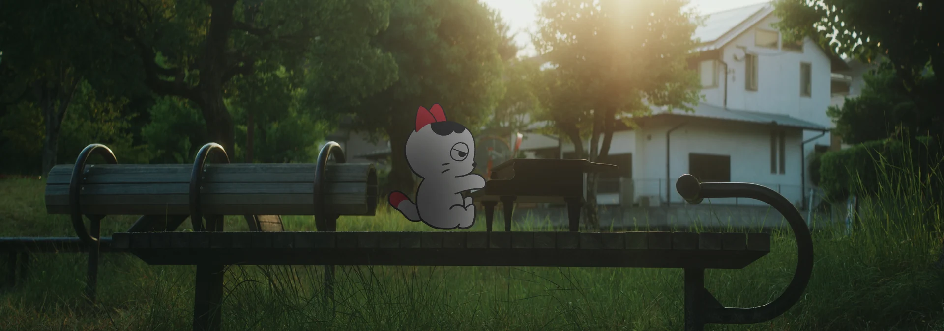 夕方の公園。ベンチの上で猫がグランドピアノを弾いている